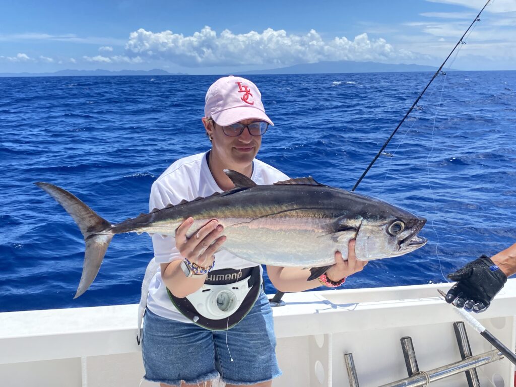 angler holding dog tooth tuna