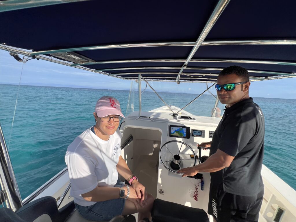 Boat captain and guest out fishing
