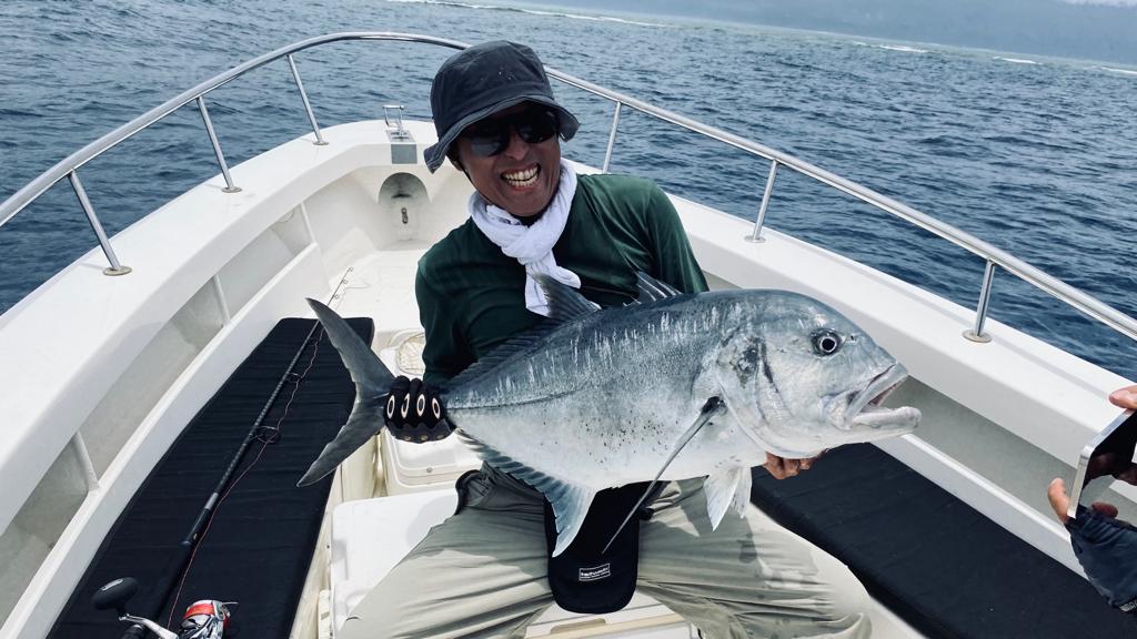Angler holding Giant Trevally